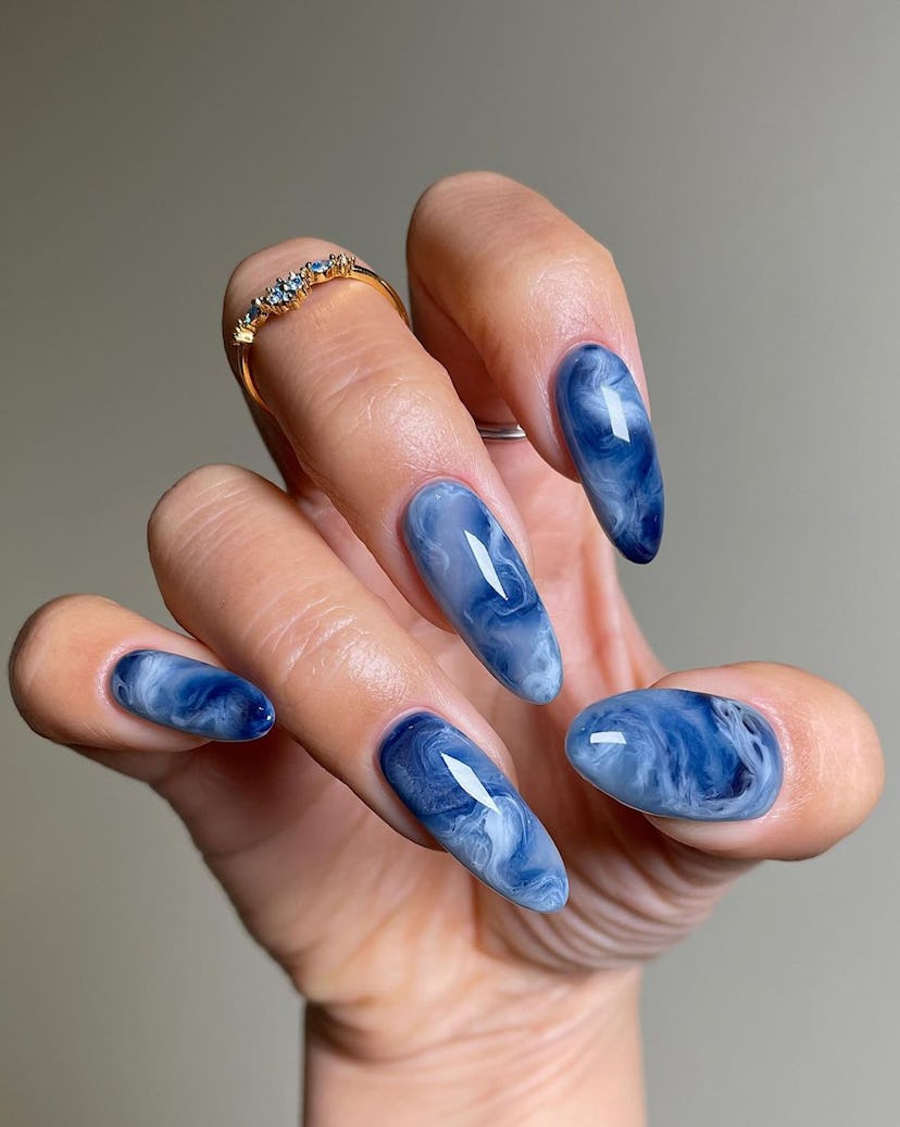 Try a blue marbled nail art design.