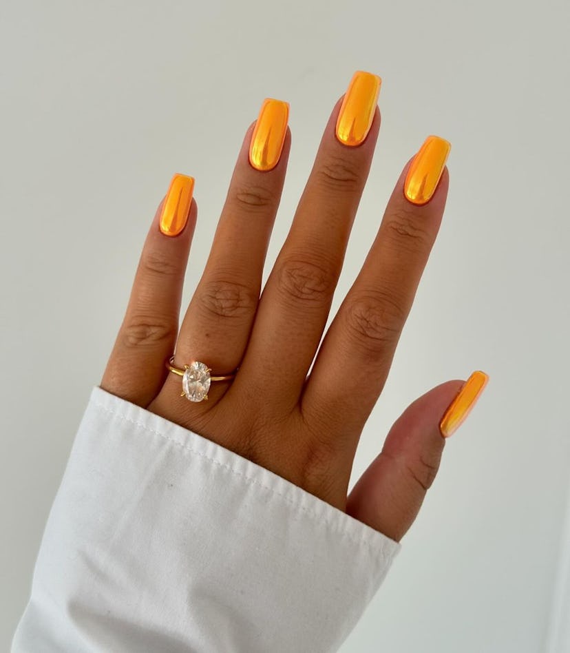 Try bright yellow-orange chrome nails for Sagittarius season 2024.