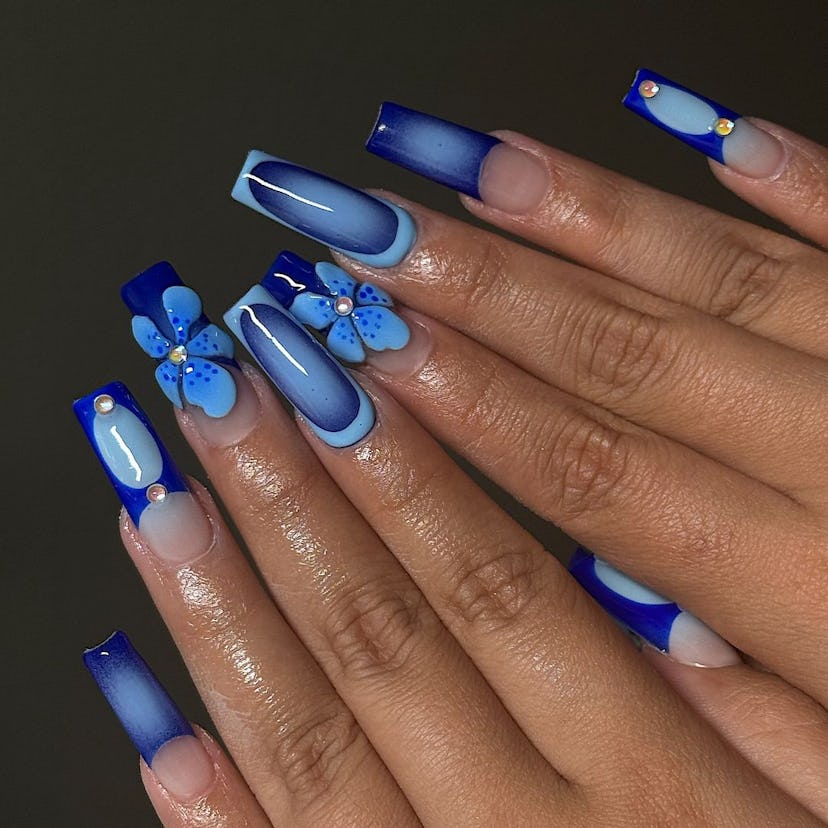 Try sapphire blue nails with 3D orchid adornments.