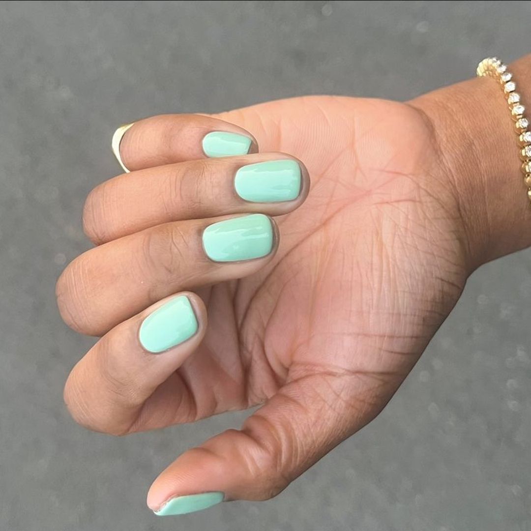 tiffany nails: Short, rounded nails painted in a fresh mint green 'tiffany blue' shade with a high gloss finish. This manicure is refreshing and cheerful, adding a pop of color in a subtle way.