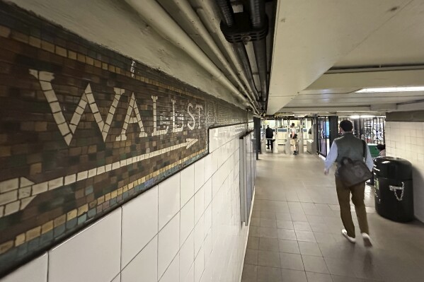 FILE - Commuters leave a Wall St. subway station in New York's Financial District on Oct. 23, 2024. (AP Photo/Peter Morgan, File)