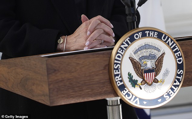 Harris's manicured hands are seen as she delivers remarks before departing the vice president's residence on October 23