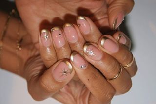 Gold french tips with star nail art