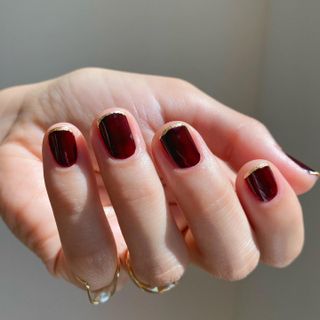 Burgundy and gold glitter french tip nails