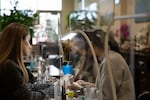 (from left) Heather Campbell gets her nals done by Three Sisters Nails employee Sarah Vo in Bend, Ore., on Nov. 18, 2024. Campbell followed Vo from where she previously worked to Huynh's salon.