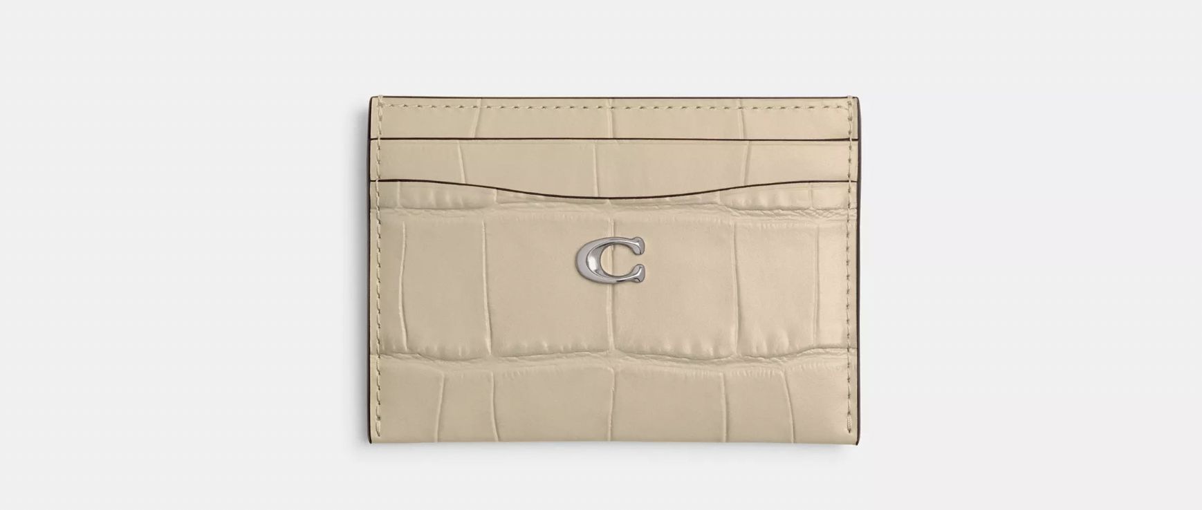 The Coach essential card case is a travel-friendly staple. (Image via Coach)