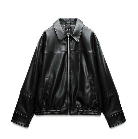 black faux leather jacket with a zip front and elastic hem