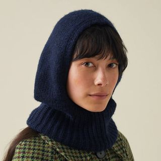 flat lay image of woman wearing navy knitted hood