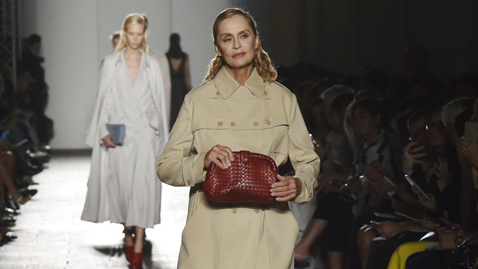 Lauren Hutton at the Bottega Veneta spring 2017 fashion show holding the Hutton 1980 red leather clutch the actress carried in the film "American Gigolo". 