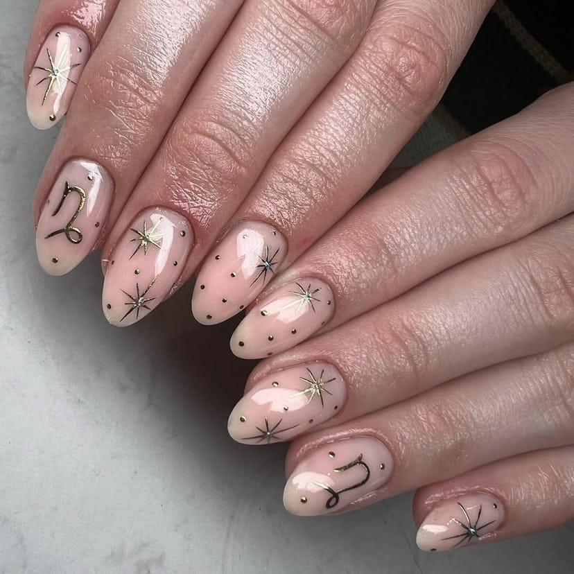 Try minimal nails with gilded symbols for Capricorn season 2025.