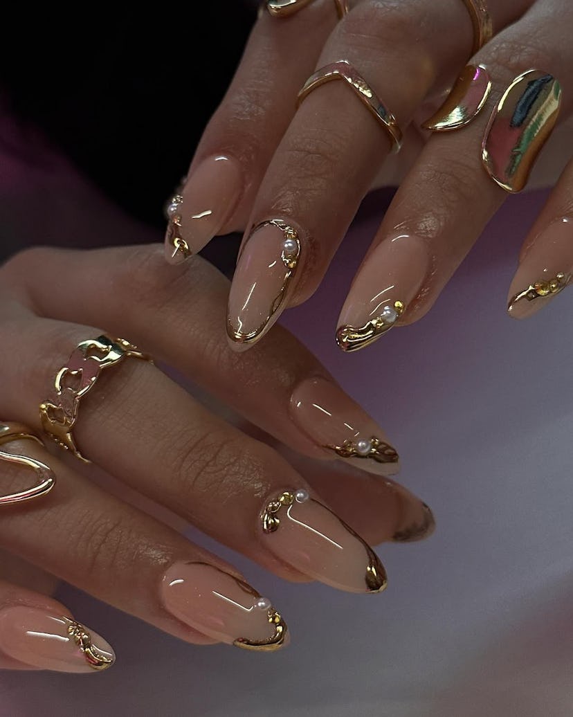 Try nails with gold chrome details for New Year's Eve 2024.
