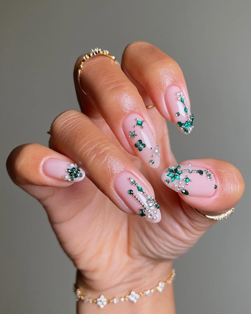 Try bedazzled emerald nails for New Year's Eve 2024.