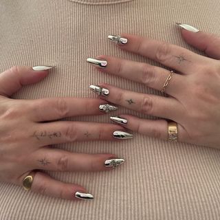 Silver chrome manicure with cross details by Brittney Boyce.