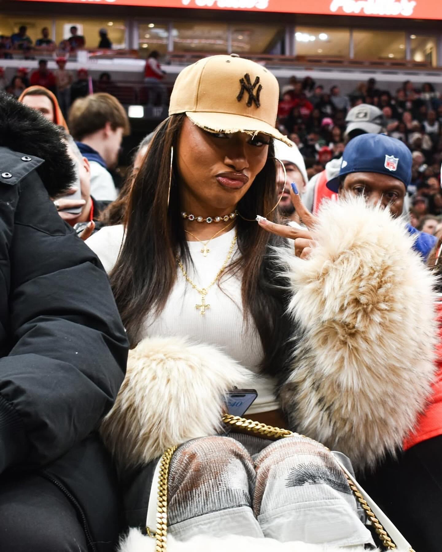 9 Megan Thee Stallion Attends The Bulls Vs Celtics Game In A DSquared Fur Coat Who Decides War Cargo Pants And A YSL Niki Oversized Fur Bag 1