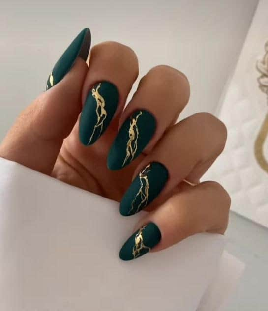 Matte Evergreen Nails with Gold Accents, one of the top festive nail trends by Mylee manicurist Tinu Bello. Photo by Sparkle PR.