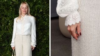 Pamela Anderson wears a white blouse and cream trousers and has a burgundy manicure at the Academy Women's Luncheon presented by CHANEL at the Academy Museum Of Motion Pictures on December 10, 2024 in Los Angeles, California.