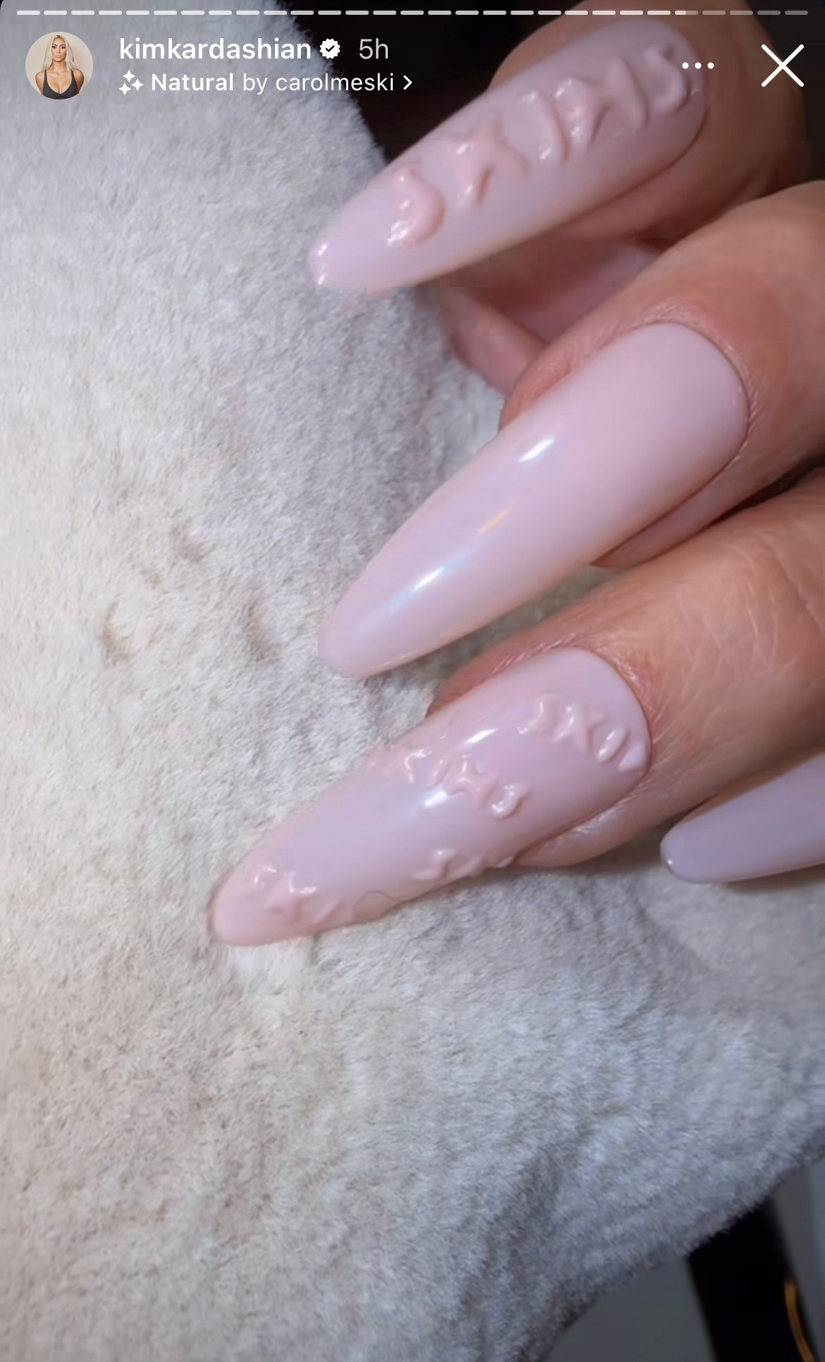 Kim Kardashian shares a photo of her pale pink manicure with 3D Skims nail art.