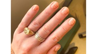 A close up of Digital Beauty Editor, Fiona McKim's gold and milky white glitter tiger print nails