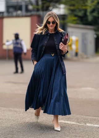 Woman in Milan wearing a navy skirt and top