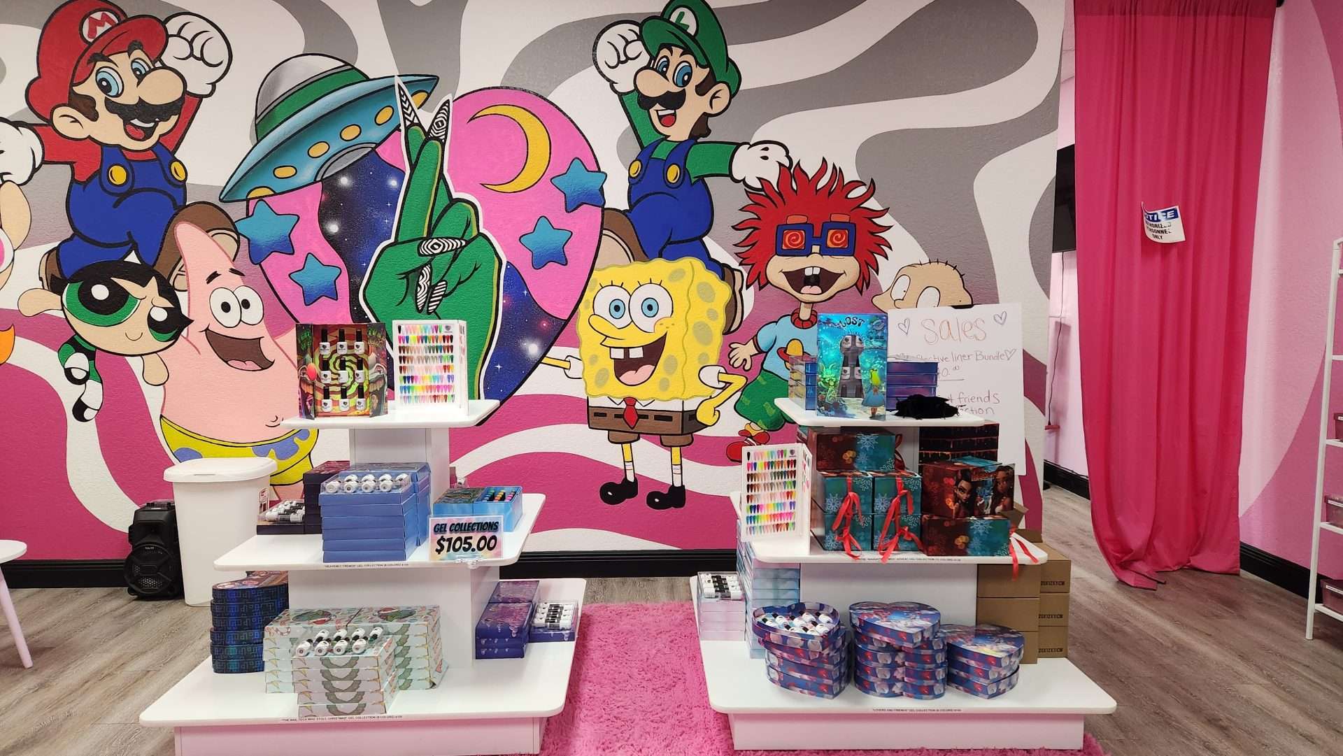 A colorful mural depicting Spongebob Squarepants is the backdrop for nail products.