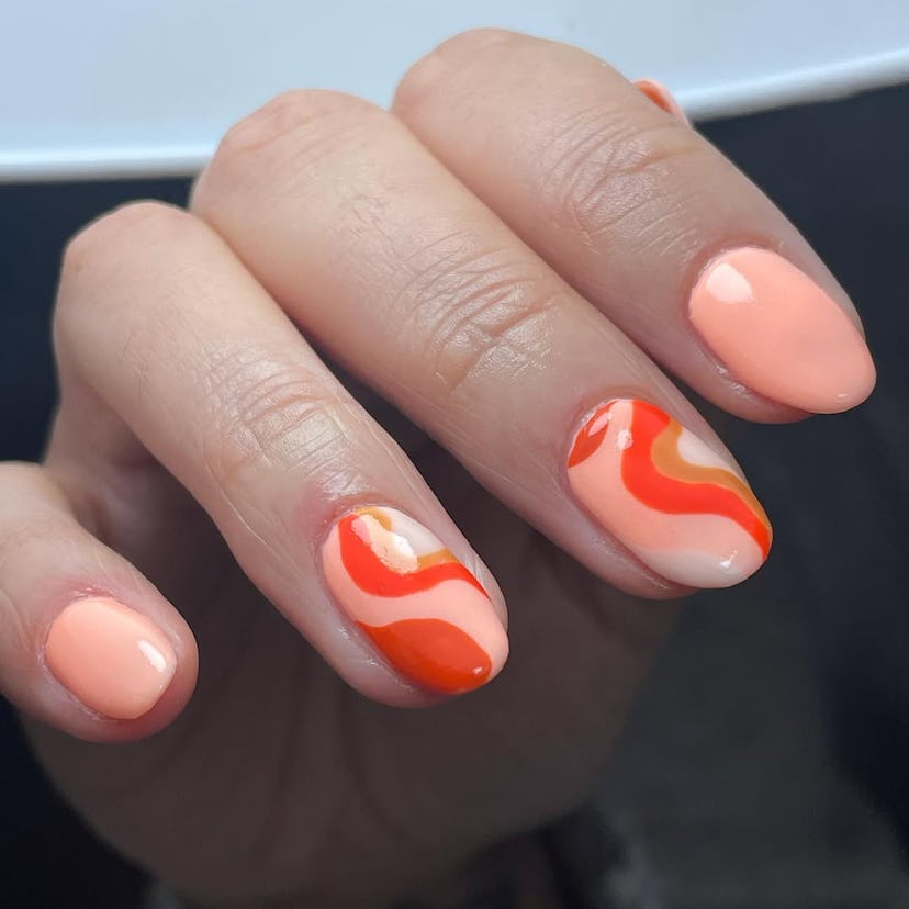 Groovy peach nail swirls match the 1960s aesthetic.