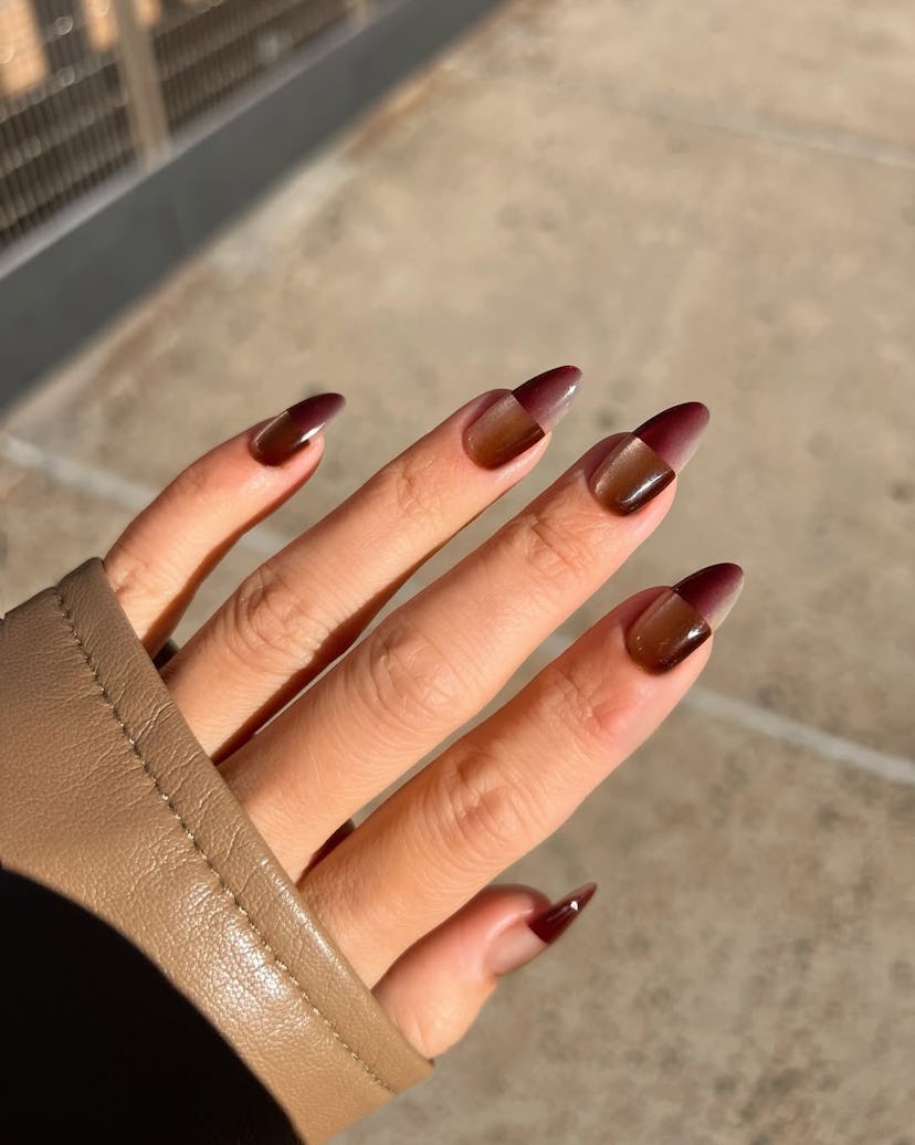 Graphic chocolate glass nails match the 1960s aesthetic.