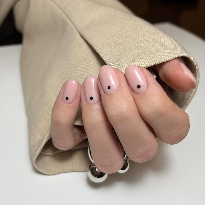 Black dot nail details match the 1960s aesthetic.