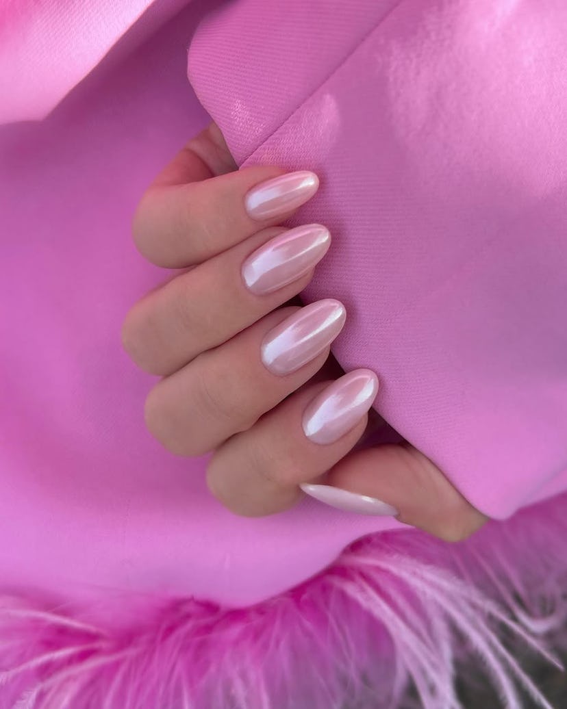 Pink glazed donut nails match the 1960s aesthetic.