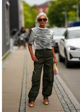 Grece Ghanam at Copenhagen Fashion Week wearing an animal print top and khaki trousers