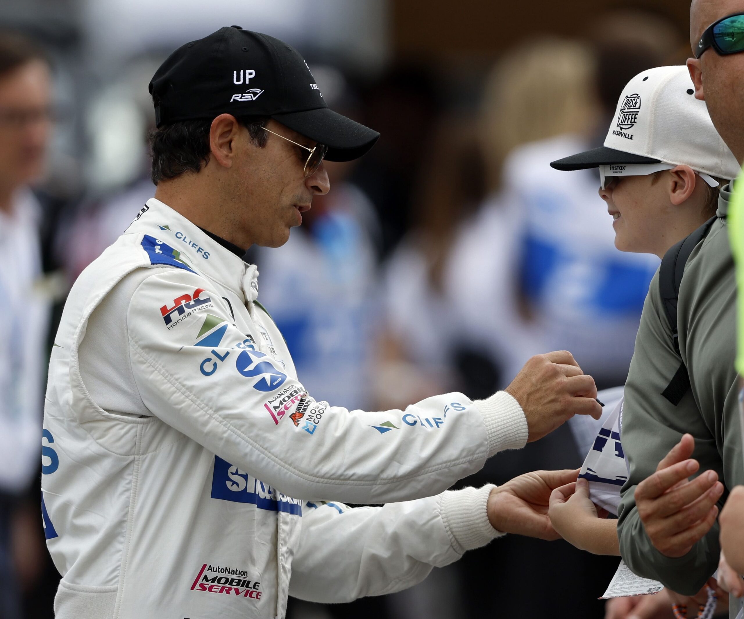 Hélio Castroneves signs an autograph before the Big Machine Music City Grand Prix at Nashville Superspeedway. - Source: Imagn