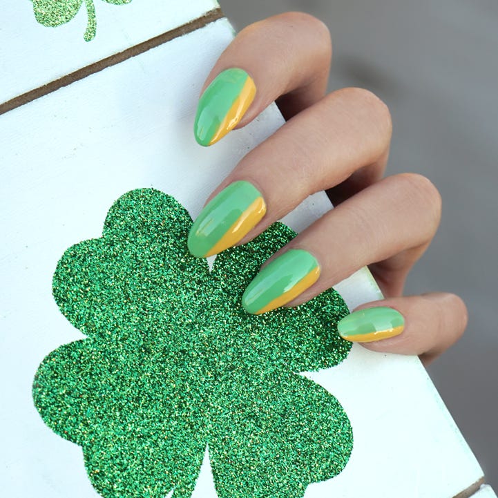 st patricks day nail ideas green gold edge female hands with a green and gold manicure for the st patricks day holiday