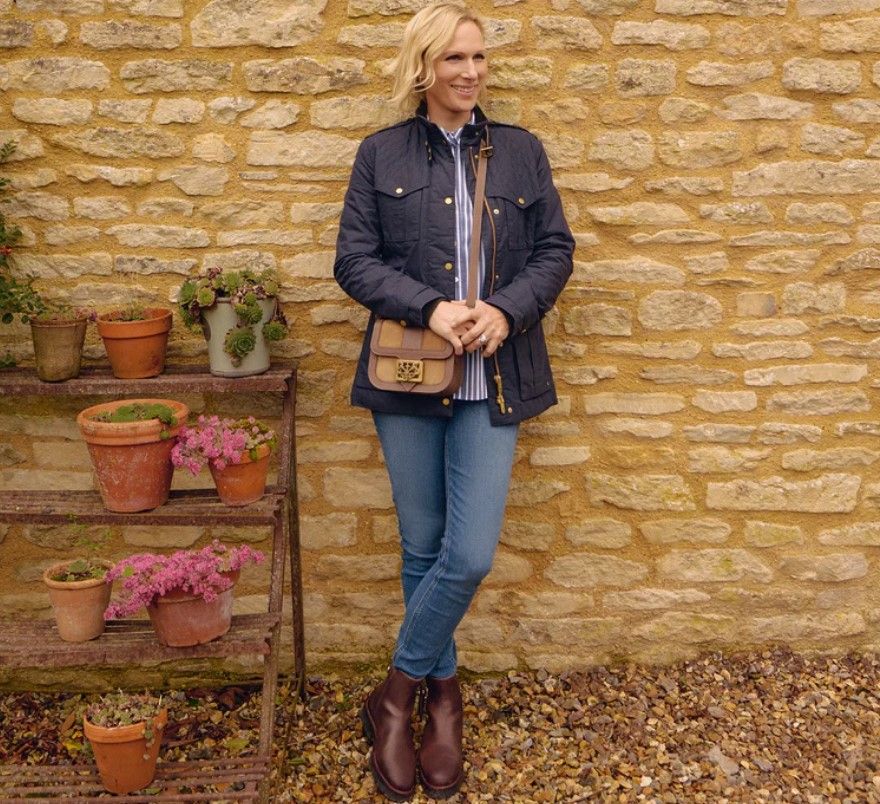 Zara Tindall wears skinny jeans and boots, a bag, and coat by Fairfax & Favor