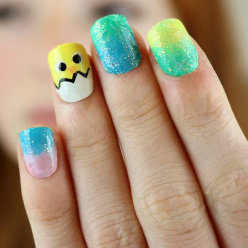 stock photo of ginger haired teenager modelling nail varnish painted with the design of a springtime easter chick