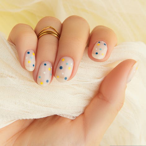 womans hand with trendy polka dot summer manicure beauty treatment spa body care concept
